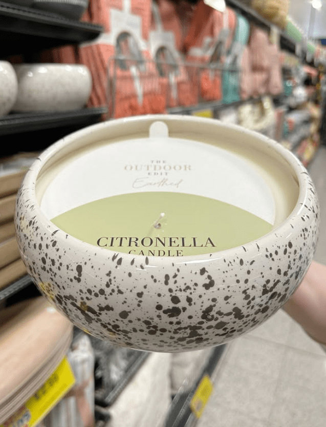 Citronella candle in speckled ceramic bowl.