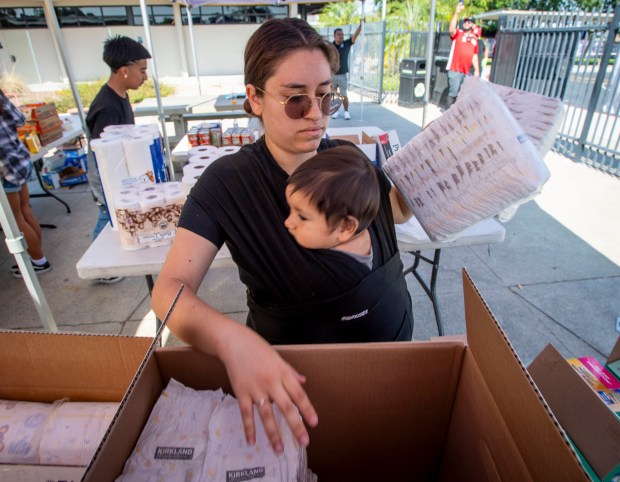 Former Santiago High School student Silvia Gutierrez and her son...