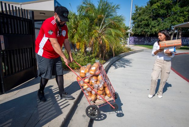Johnny Mejia brings in donated bread at the Santiago High...