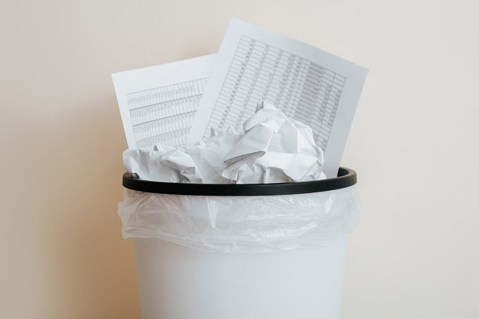 Close-up of crumpled paper, documents in trash can
