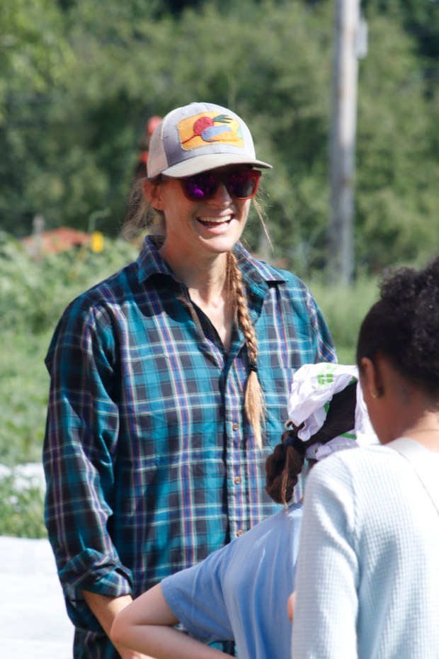Katie Taylor, the farmer manager of Easton Urban Farm, leads children through the garden Monday, June 30, 2025, in Easton as she identifies produce and explains its growing timeline and usage. Easton Urban Farm invited children ages 5-10 for a tour of the garden, an opportunity to pick raspberries and an art session to paint a gazebo. The nonprofit, which is connected to the Neighborhood Center's Food Pantry, supplies fresh produce to low-income families. (Oliver Lois Economidis/The Morning Call)