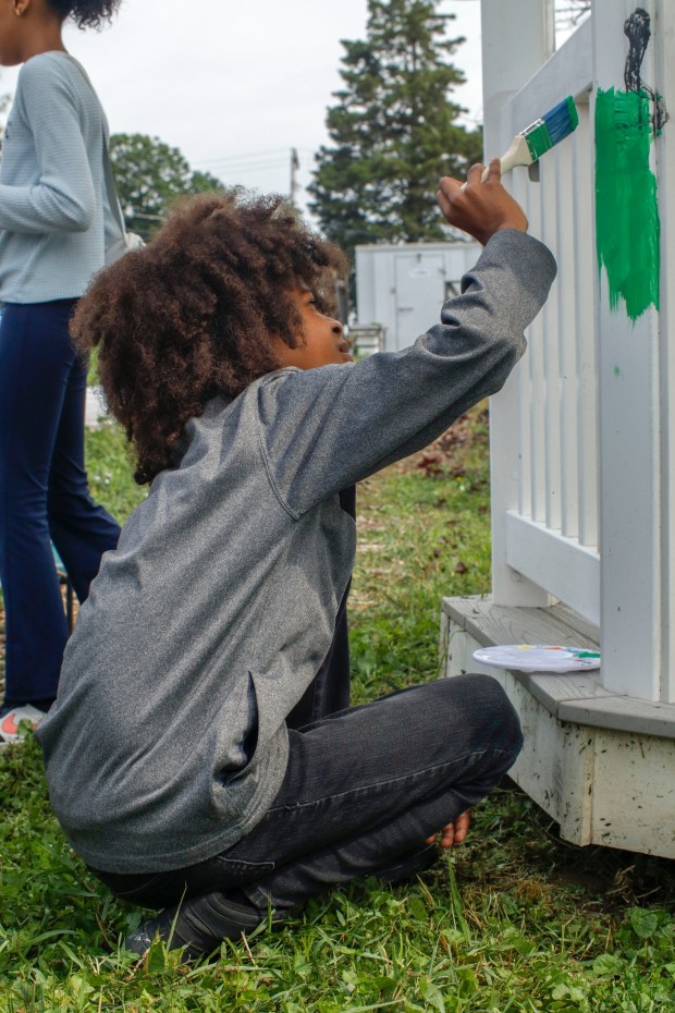 Children, staff and parents work together to paint the Easton Urban Farm's gazebo Monday, June 30, 2025. The nonprofit, which supplies fresh produce to low-income families, invited children ages 5-10 for a tour of the garden, an opportunity to pick raspberries and an art session to paint the gazebo. (Oliver Lois Economidis/The Morning Call)