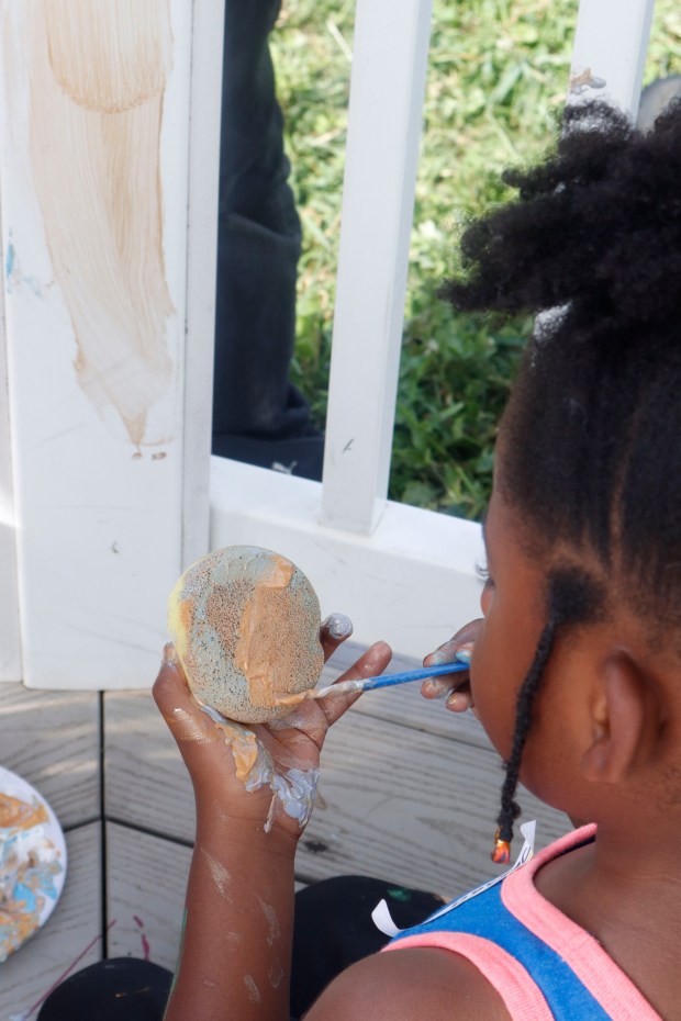Children, staff and parents work together to paint the Easton Urban Farm's gazebo Monday, June 30, 2025. The nonprofit, which supplies fresh produce to low-income families, invited children ages 5-10 for a tour of the garden, an opportunity to pick raspberries and an art session to paint the gazebo. (Oliver Lois Economidis/The Morning Call)