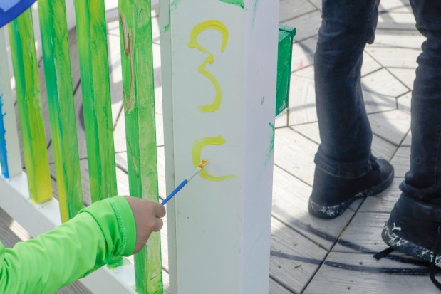Children, staff and parents work together to paint the Easton Urban Farm's gazebo Monday, June 30, 2025. The nonprofit, which supplies fresh produce to low-income families, invited children ages 5-10 for a tour of the garden, an opportunity to pick raspberries and an art session to paint the gazebo. (Oliver Lois Economidis/The Morning Call)
