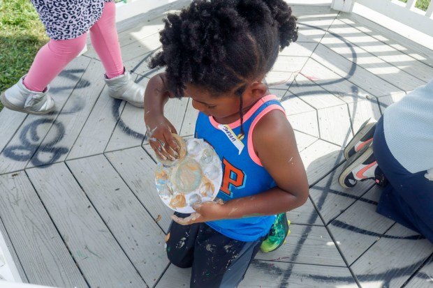 Children, staff and parents work together to paint the Easton Urban Farm's gazebo Monday, June 30, 2025. The nonprofit, which supplies fresh produce to low-income families, invited children ages 5-10 for a tour of the garden, an opportunity to pick raspberries and an art session to paint the gazebo. (Oliver Lois Economidis/The Morning Call)