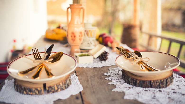 White doilies are used under nature-inspired place settings