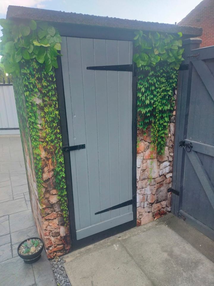 Outhouse transformed with stone and ivy print.