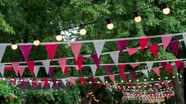 Rows of pink and white bunting are hung in a long row
