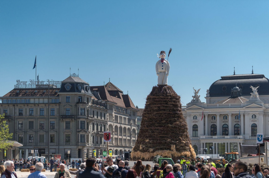 People from Zurich gather around the burning of the Böögg on Sechseläuten.