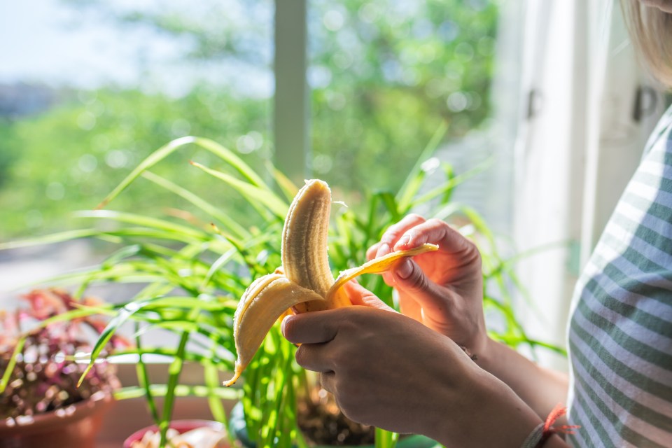 Woman peeling a banana.