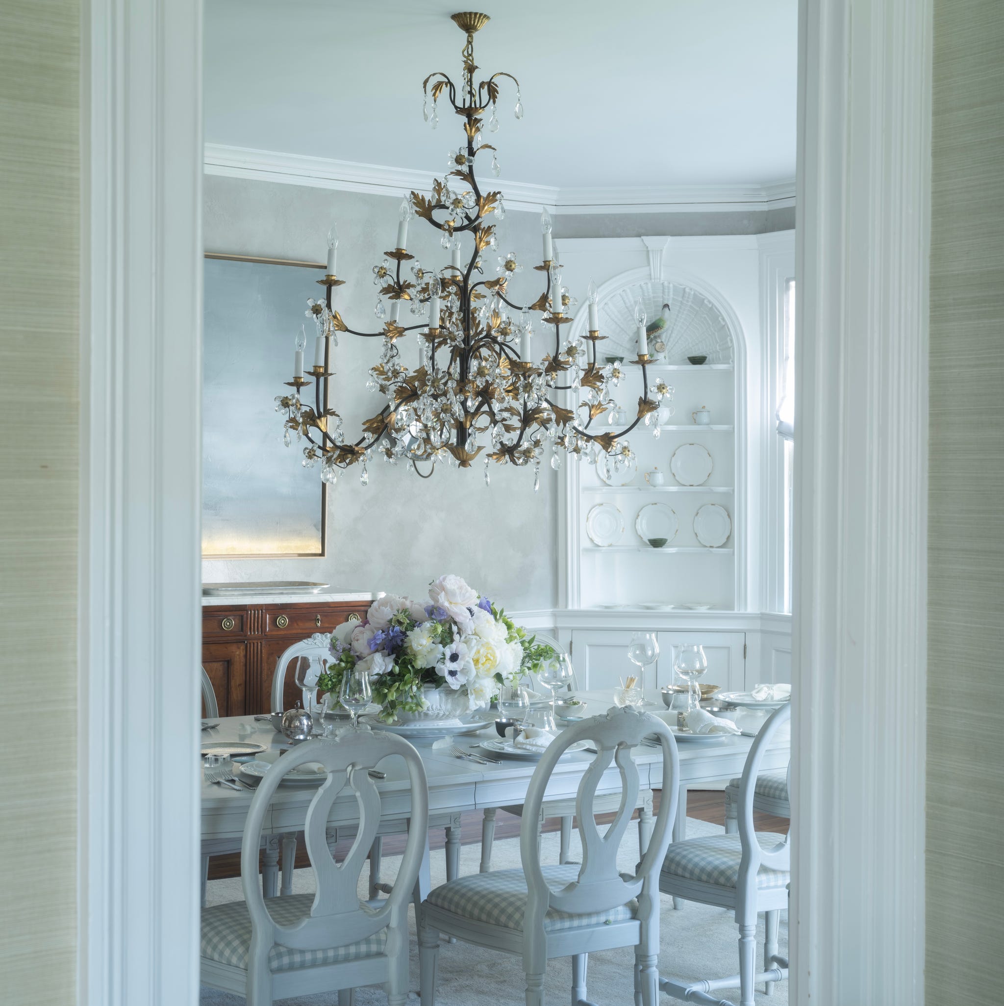 gray dining room with elaborate chandelier