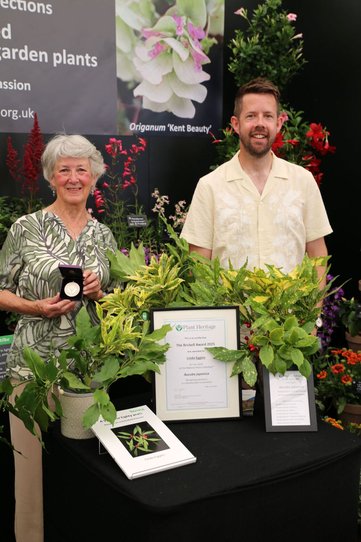 Midlands gardener wins prestigious horticultural award at RHS Hampton Court Palace Garden Festival 2025 Linda Eggins, National Plant Collection Holder of Aucuba japonica and winner of Plant Heritage’s Brickell Award 2025 with Matthew Pottage at RHS Hampton Court Palace Garden Festival. Credit Plant Heritage.