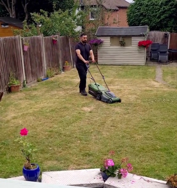 Man mowing dry lawn.
