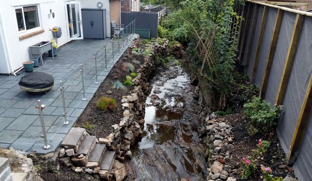 The image shows the brook beside the patio area