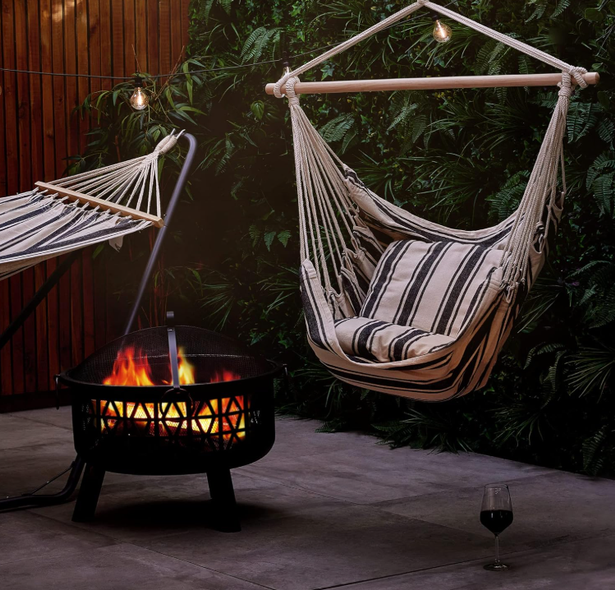 The VonHaus hanging seat from Amazon in a dark garden