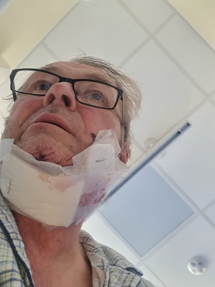 Close-up of a man with a neck wound bandaged.