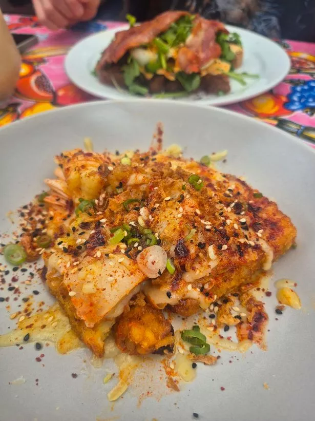 The cheesy kimchi hash browns at Caneat