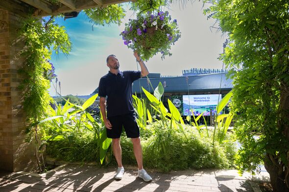 Head gardener Martyn Falconer inspects the Wimbledon flowers Head gardener Martyn Falconer inspects the Wimbledon flowers