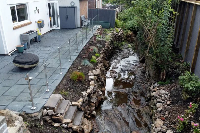 The image shows the brook beside the patio area