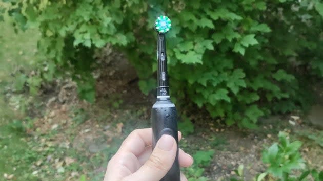 An electric toothbrush in garden