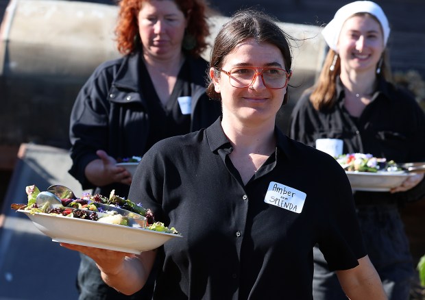 Amber Parker and other volunteers bring out the salad course...