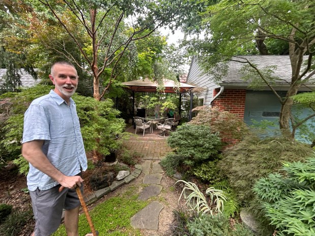John Thesing stands in his back garden. (Frank Mecham- The News-Herald)