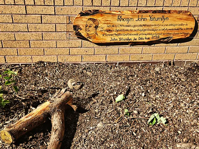 A handcrafted sign at Cwm Rhymni's new John Ystumllyn memorial kitchen garden