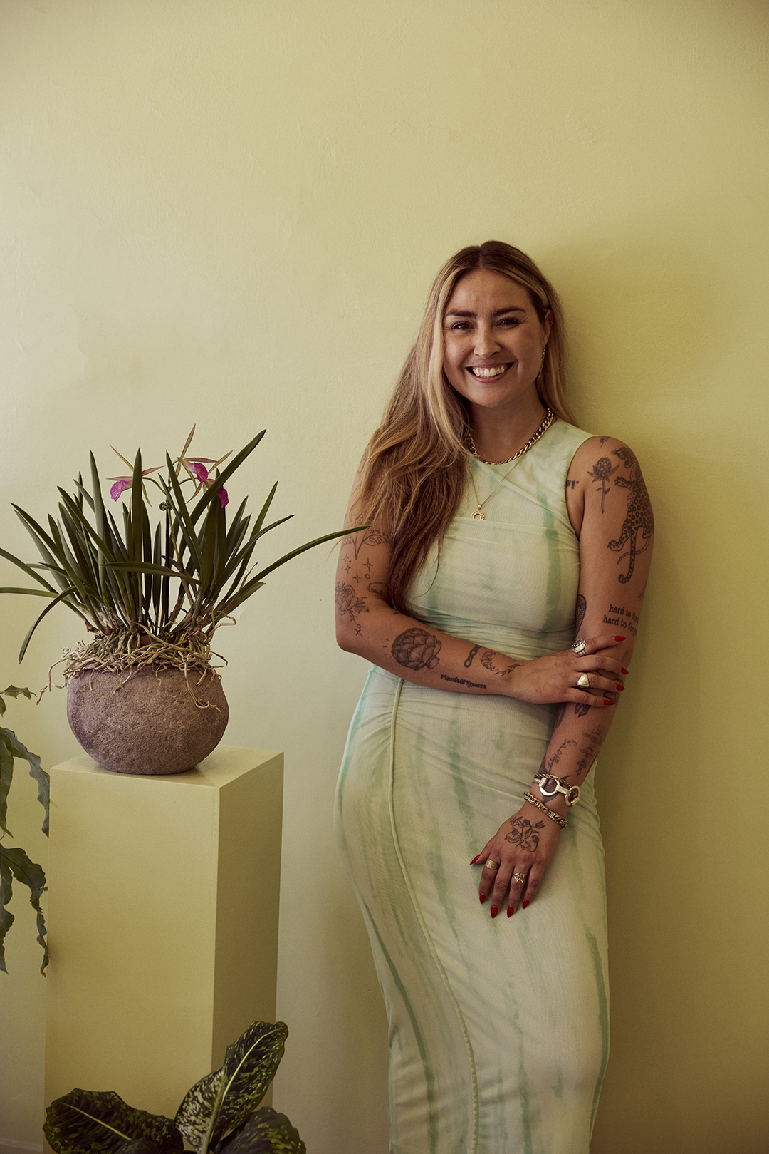 Zilah Drahn next to plant on pedestal