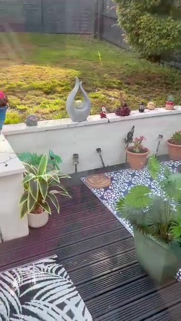 Garden patio with plants and decorations.