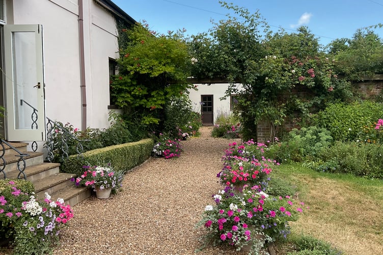 A view of a garden pathway at Efford House, Efford near Shobrooke.