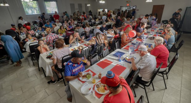 People enjoy breakfast before the parade at the Winter Garden Masonic Lodge All American Kids Parade & Breakfast in downtown Winter Garden on Friday (Ricardo Ramirez Buxeda/Orlando Sentinel)