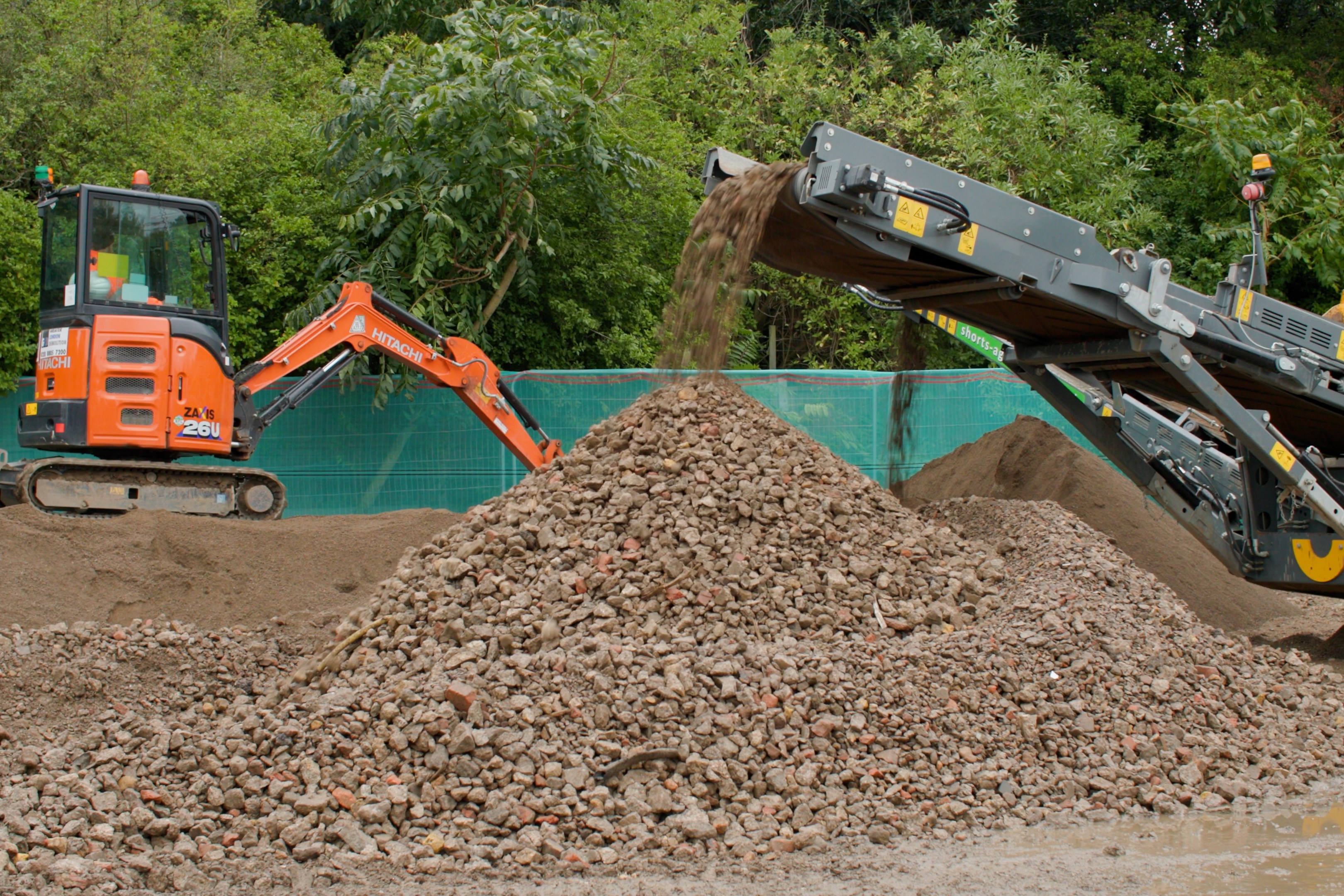 Concrete being crushed for a climate-resilient garden.