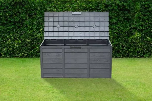 The Weatherproof Black Plastic Garden Storage Box, on a lawn
