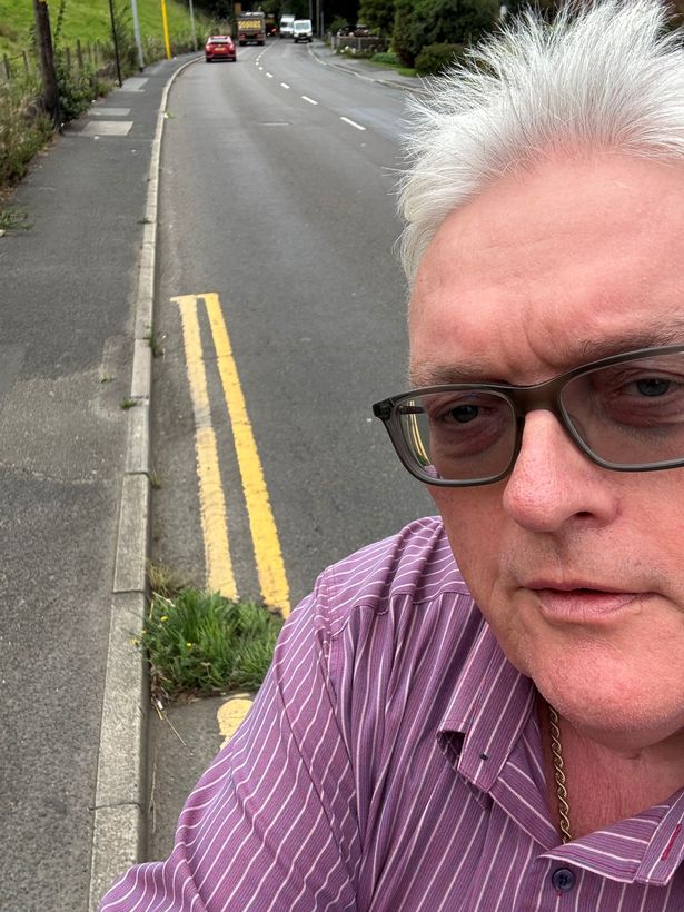 Shaw councillor Howard Sykes next to an 'overgrown' gully on Milnrow Road. 