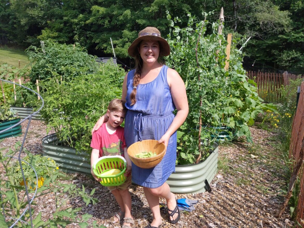 Growing a local food system at the Inlet Community Garden Alicia Kress and her son Ryker, in front of their garden bed at the Inlet Community Garden. Photo: Amy Feiereisel