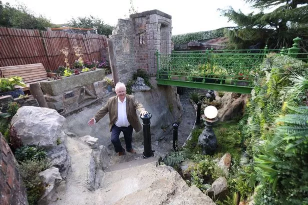 Francis Proctor on the steps down to the cave at the bottom of his garden in Southport