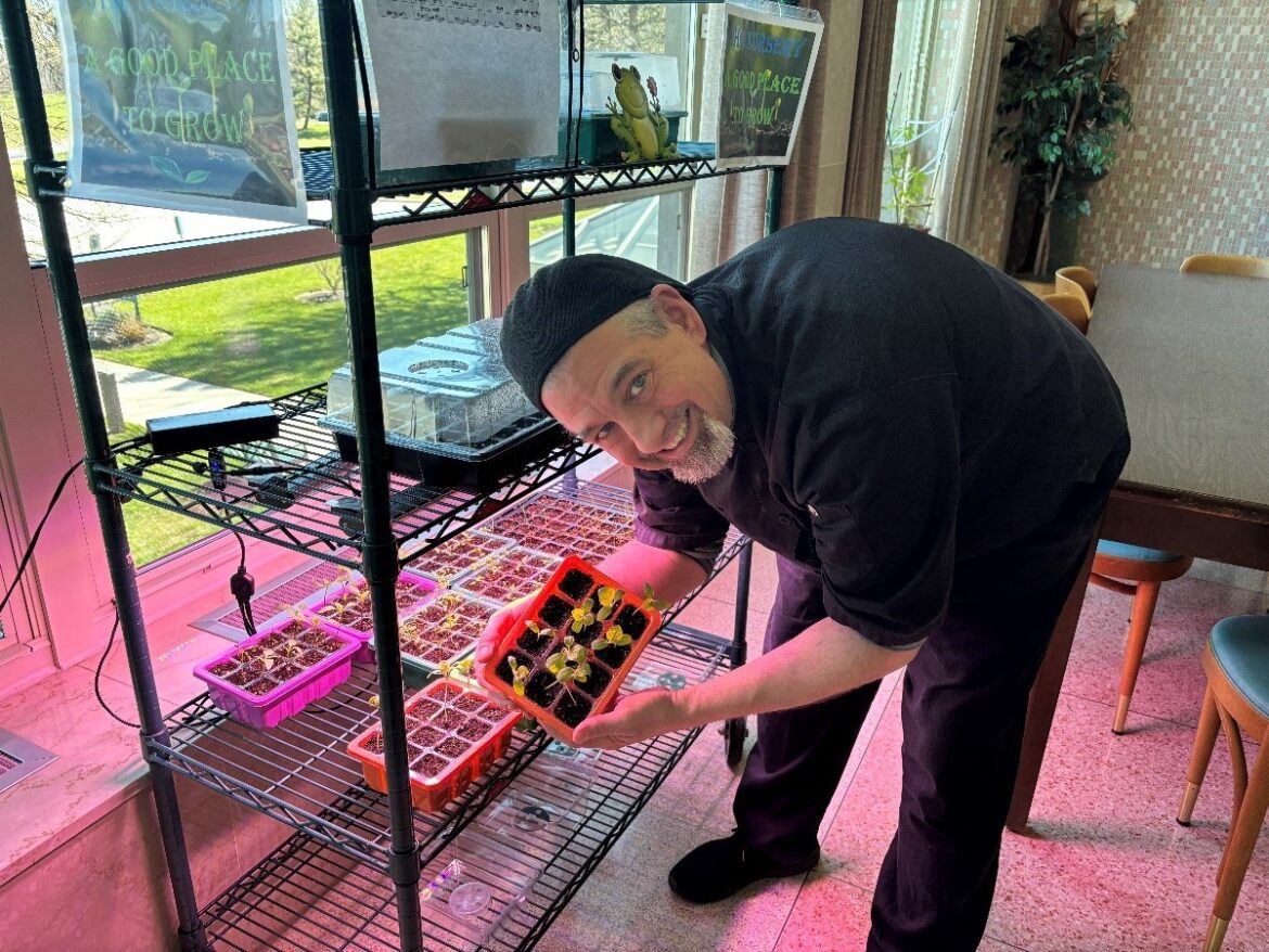 Peace Garden Flourishes at IHM Motherhouse in Malvern Executive Chef Craig Tinley holding trays of 2024 seedlings prepared for the first season of the Peace Garden at the IHM Motherhouse in Malvern.