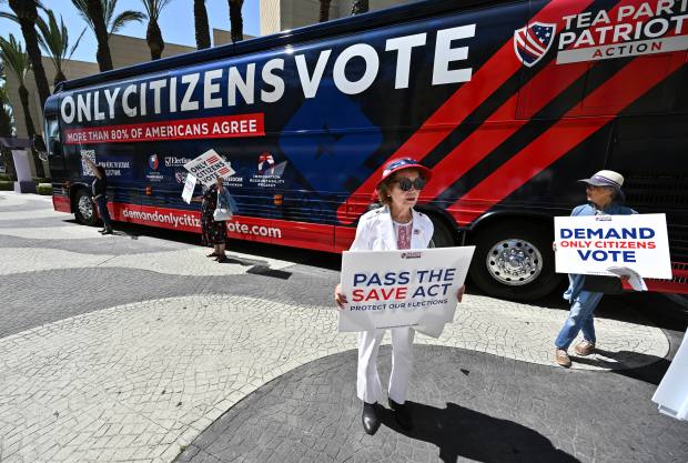 Ngan Nguyen, of Santa Ana, joins other supporters of the...