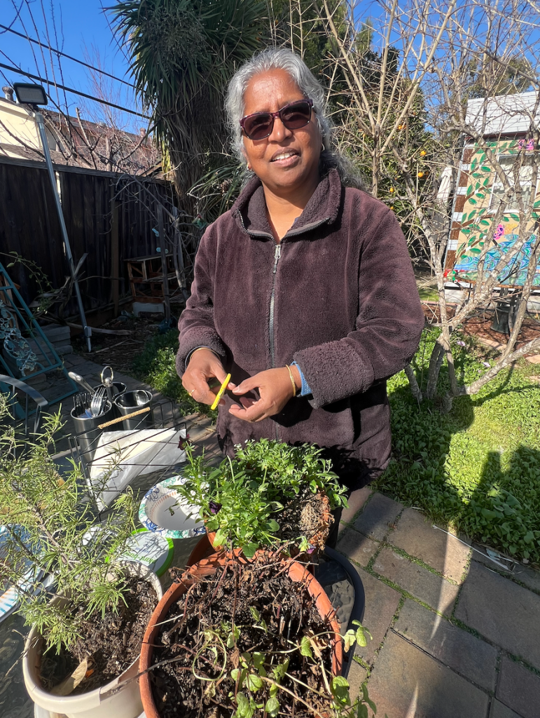 A woman gardens at a table