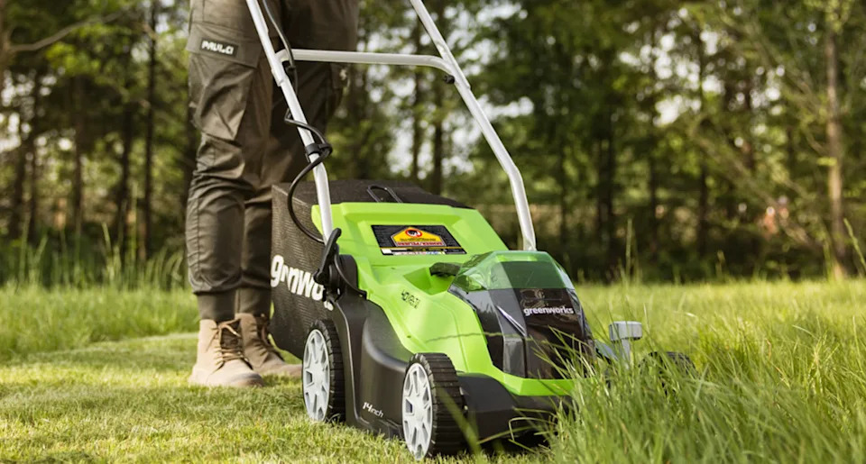 someone using a Greenworks 40V 14-Inch Lawn Mower