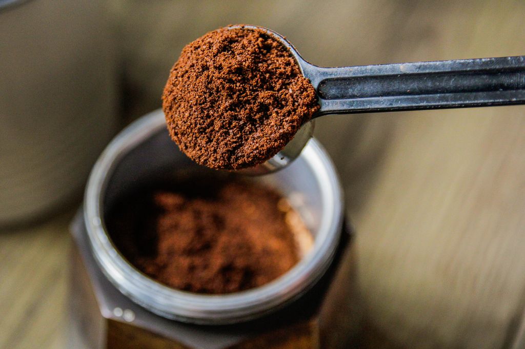 Ground coffee on spoon