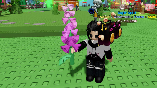 A character holding a plant in Grow a Garden.