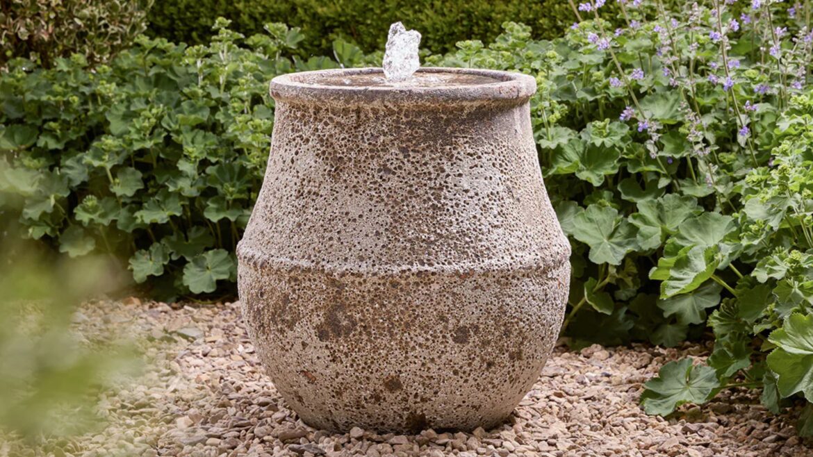 ‘Water Feature Pots’ Add Peace, Not Plumbing, to Your Garden | water feature pot on gravel garden with hedges around it