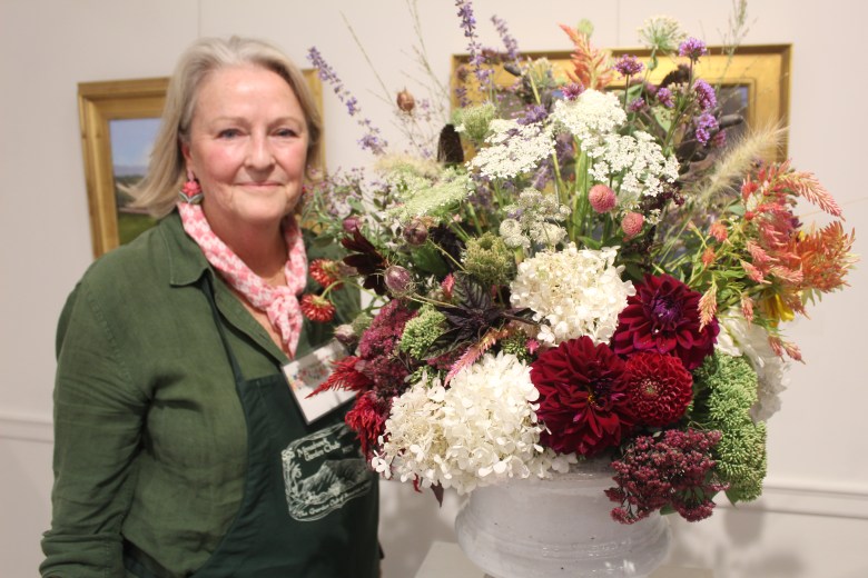 Jeanne Henriques of Peterborough with her floral display, based off the imagery in the T.S. Eliot poem "Rhapsody on a Windy Night." ASHLEY SAARI/Ledger-Transcript