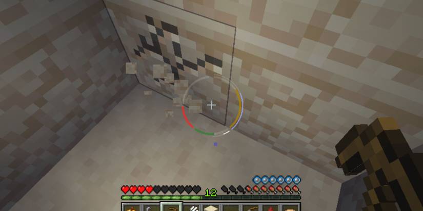 A player breaking a sandstone block with a wood pickaxe has a unique, circular HUD element around their crosshair.