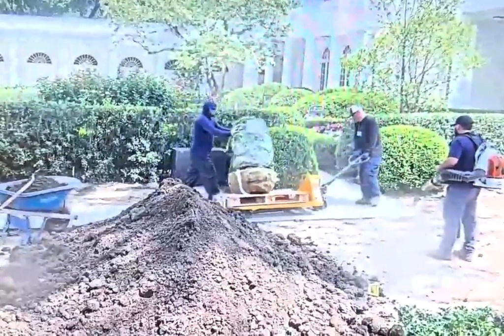 Workers removing a damaged stone from the White House Rose Garden.