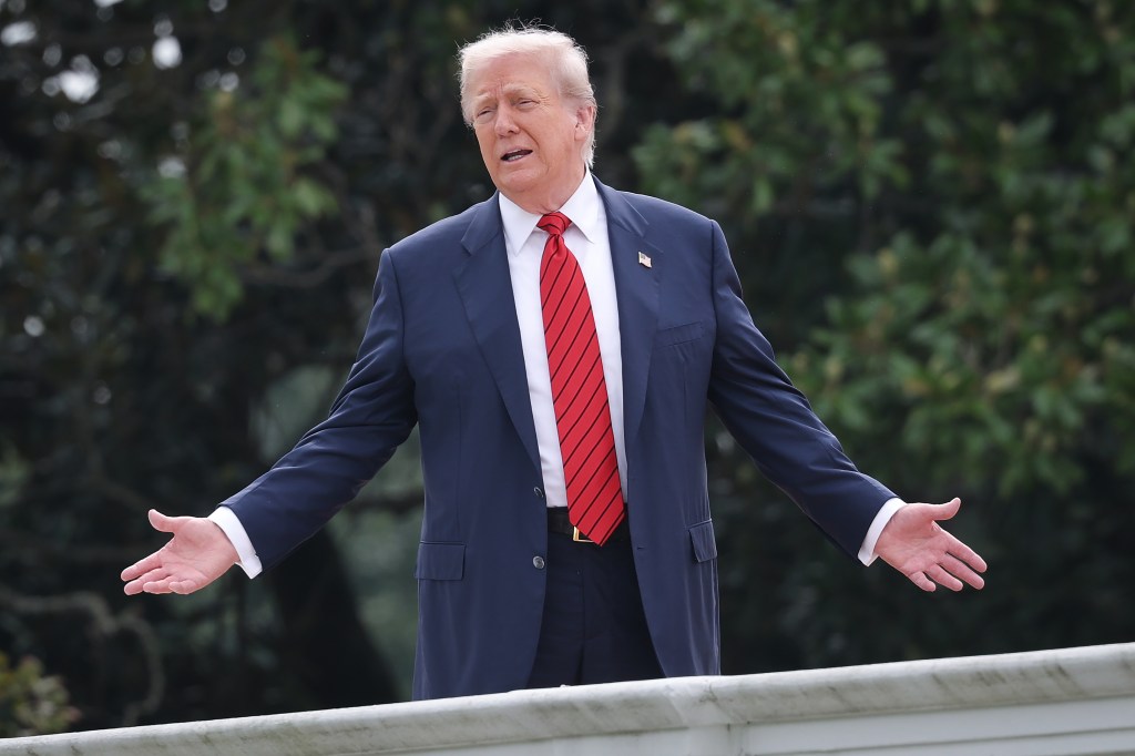 President Trump gesturing while on the White House West Wing roof.