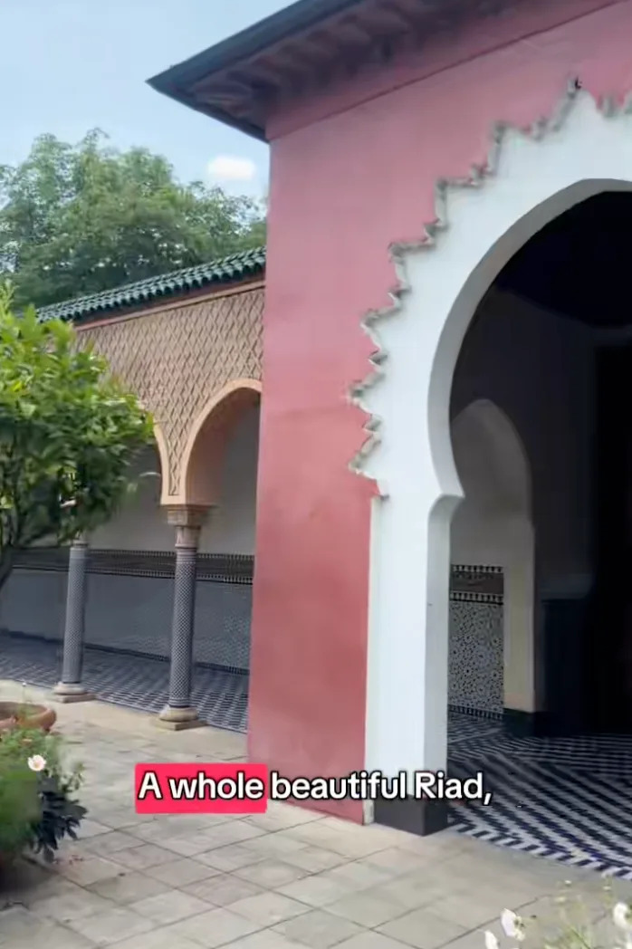Exterior of a riad with ornate arches and tilework. Text reads: "A whole beautiful Riad."