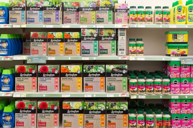Shelves with boxes of Levington and other fertilizer products, Notcutts garden center, Woodbridge, Suffolk, England, UK.