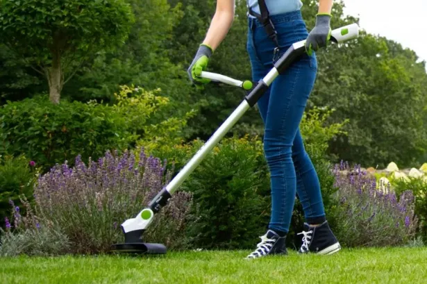 someone using a grass trimmer